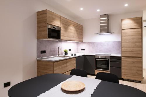 a kitchen with a black table and chairs and cabinets at Palazzo Chimelli in Pergine Valsugana