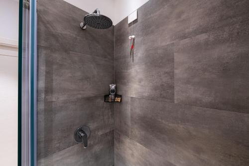 a bathroom with a shower with a glass door at Palazzo Chimelli in Pergine Valsugana
