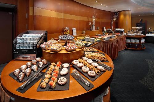 a buffet line with many different types of donuts at HCC Montblanc in Barcelona