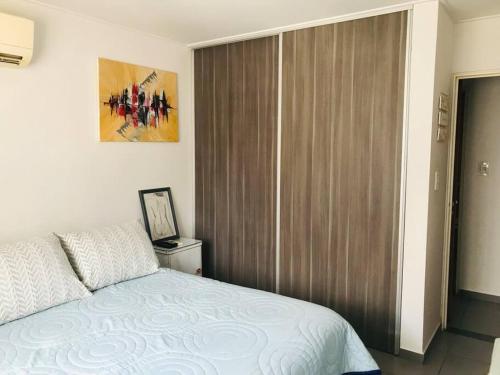 1 dormitorio con cama y ventana grande en Habita Plaza -Dpto en Barrio General Paz con Pileta Sum en Córdoba