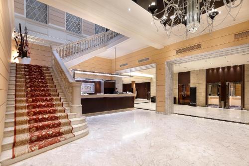 a lobby with a staircase in a building at HCC St. Moritz in Barcelona