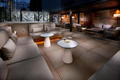 a living room with couches and a table at HCC St. Moritz in Barcelona