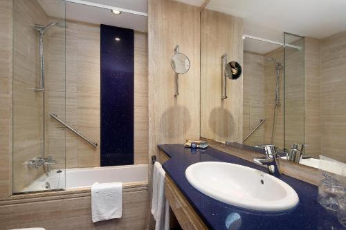a bathroom with a sink and a shower and a tub at HCC St. Moritz in Barcelona