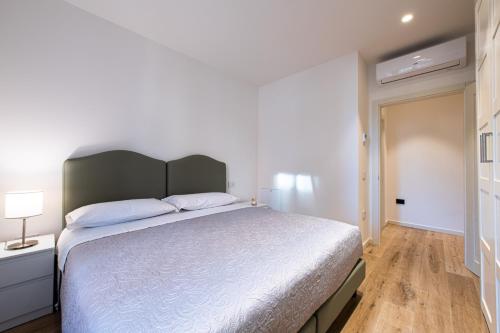 a bedroom with a large bed and a wooden floor at Palazzo Chimelli in Pergine Valsugana
