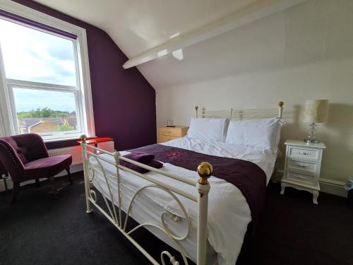 a bedroom with a white bed and a window at Crittlewood Guest House in Morton