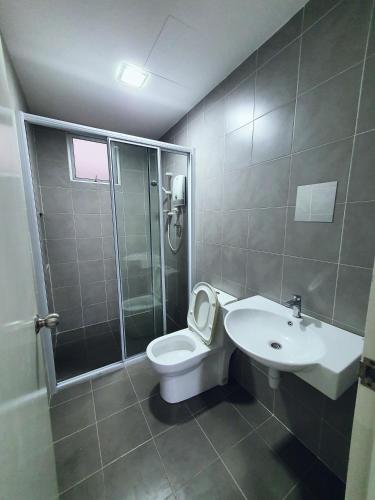 a bathroom with a toilet and a shower and a sink at New Modern Condo with Pool at Bangi in Kampong Tangkas