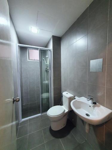 a bathroom with a toilet and a shower and a sink at New Modern Condo with Pool at Bangi in Kampong Tangkas