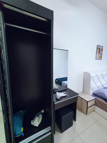 a bedroom with a bed and a black door with a desk at New Modern Condo with Pool at Bangi in Kampong Tangkas