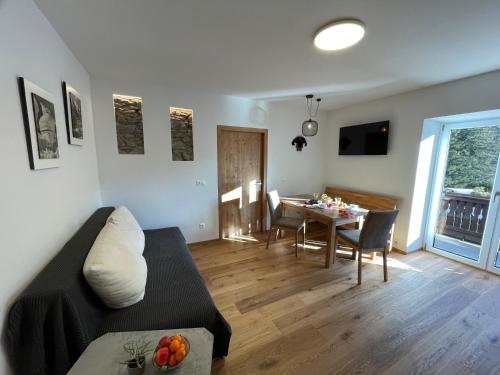 a living room with a couch and a table at appartementsKOFLER in Mallnitz