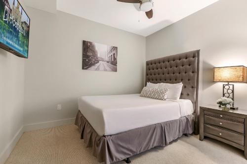 a bedroom with a large bed and a nightstand at Modern Condo with Game Room in Downtown New Orleans in New Orleans