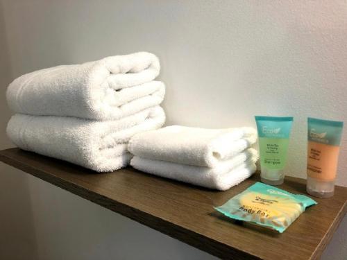 a wooden shelf with towels and a bottle of soap at Waterway Inn in Indian River