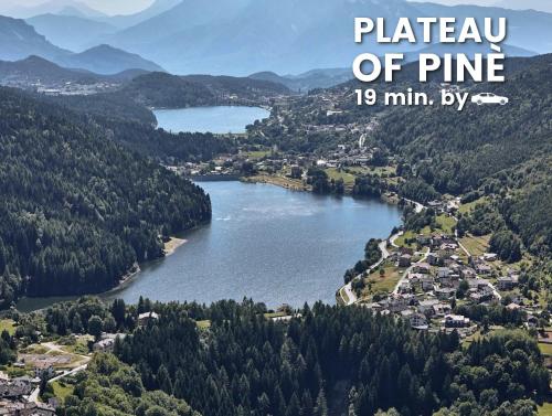 a view of a lake with mountains in the background at Palazzo Chimelli in Pergine Valsugana