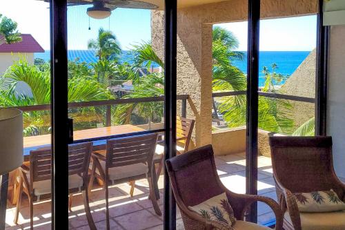 a dining room with a view of the ocean at Downtown Kona Condo with Pool Access Walk to Beach! in Kailua-Kona