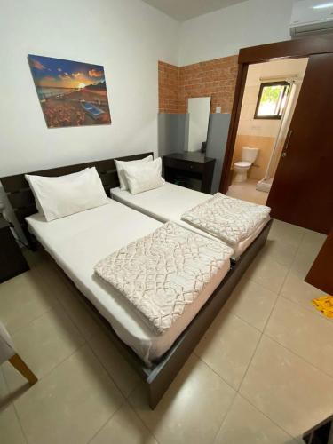a bedroom with two beds and a desk at Marina's Rooms in Larnaka