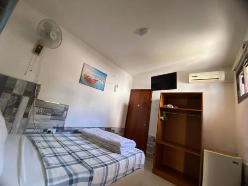 a small bedroom with a bed and a dresser at Marina's Rooms in Larnaka