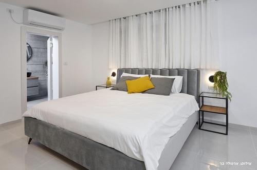 A bed or beds in a room at אחוזת שקד בוטיק - מתחם פרטי 3 חדרי שינה, בריכה מחוממת , ג'קוזי ונוף בגליל המערבי