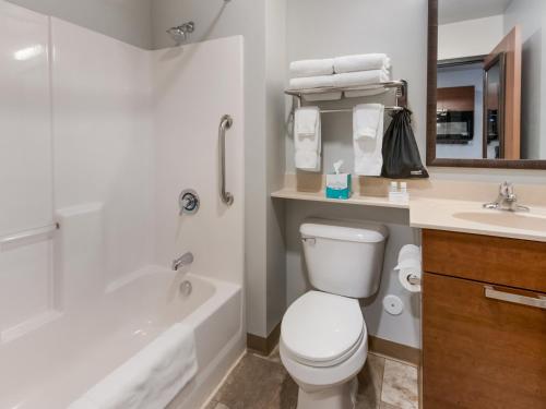 La salle de bains est pourvue de toilettes, d'une baignoire et d'un lavabo. dans l'établissement My Place Hotel-Bozeman, MT, à Bozeman