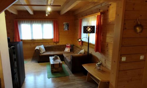 a living room with a couch and a table at Ferienhütten Zimmermann in Spital am Semmering