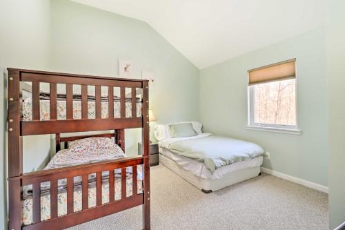 a bedroom with two bunk beds and a window at Spacious East Stroudsburg House Game Room and Yard! in East Stroudsburg