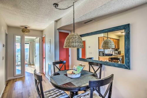 a dining room with a table and a mirror at Condo with Pool Access - Walk to Beach! in Carolina Beach