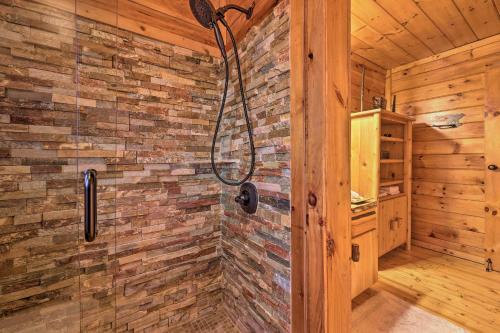 a bathroom with a shower in a wooden cabin at 'Sleeping Bear Cabin' Coosawattee! Dog Friendly! in Ellijay