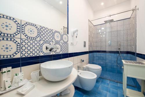 a bathroom with a sink and a toilet and a shower at Villa Tesoro in Positano