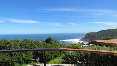 a view of the ocean from the balcony of a house at Castle On The Heads in Knysna