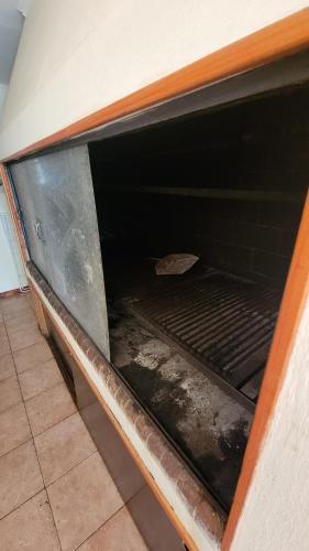 an oven with a dirty inside of it at Chalet Mar del Plata in Mar del Plata