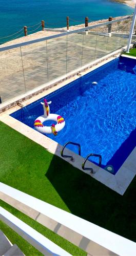 an empty swimming pool with an inflatable at Wadi Shab Beach Villa in Sur