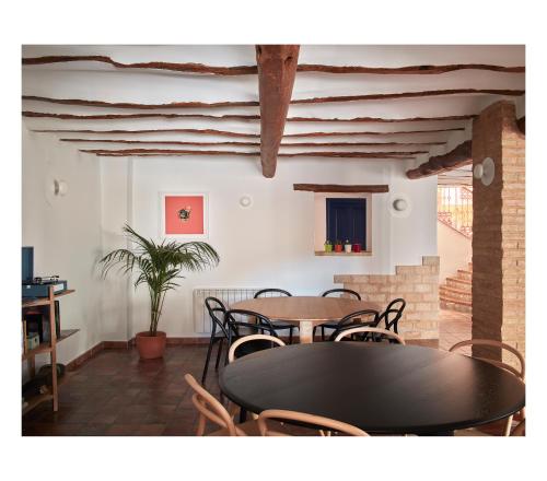 a dining room with tables and chairs and a plant at Casa Neleman 