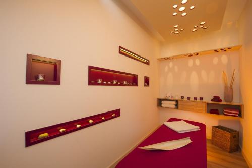 a room with a red table and a mirror at Hotel im Auerbachtal in Bad Laasphe