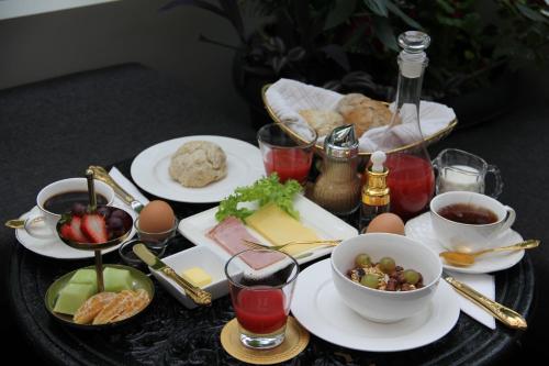 a table topped with plates of food and drinks at Vinnhaus in Puerto Natales