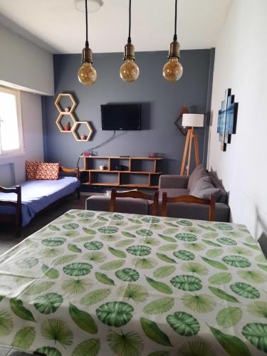 a living room with a table and a couch at Departamento Brown - zona centro in Mar del Plata