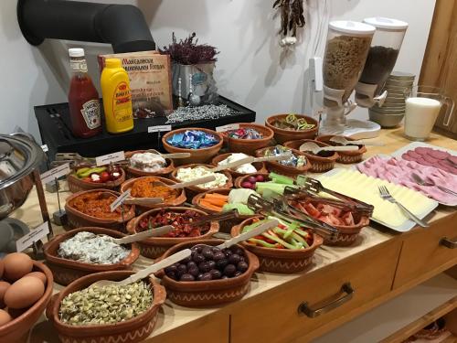 a buffet with many bowls of food on a table at Penzion Modrý Pavilon in Dolní Malá Úpa