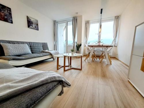 a living room with a couch and a table at Schmidis Ferienwohnung Sonthofen in Sonthofen