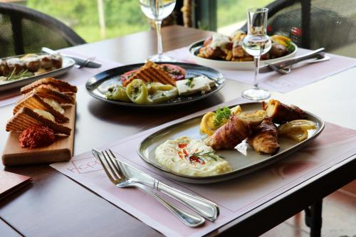 a table with three plates of food on it at Hotel Happy in Dimitrovgrad
