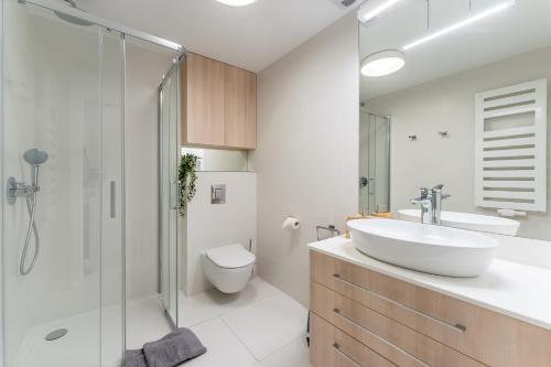 łazienka z umywalką, toaletą i prysznicem w obiekcie Sunrise Apartament w Rogowie