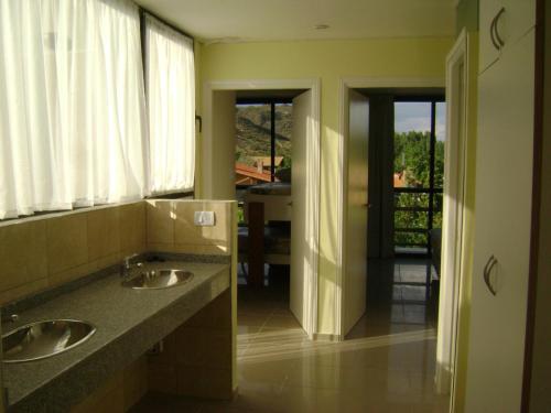 a bathroom with two sinks and a mirror at Chalet en Valle Grande - En Solar del Valle Country Club in Valle Grande