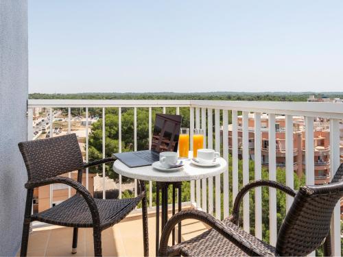 a balcony with a table with a laptop on it at Hotel Torre Azul & Spa - Adults Only in El Arenal