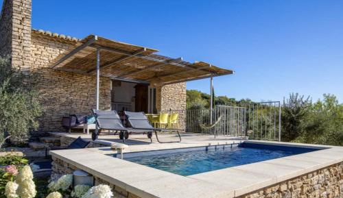 eine Terrasse mit Pool und ein Haus in der Unterkunft l'Atelier des Milles Roches in Gordes