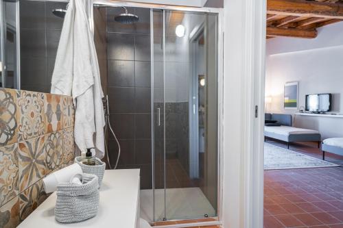 a bathroom with a shower with a glass door at Maestranza72 by Bed&Bros in Siracusa