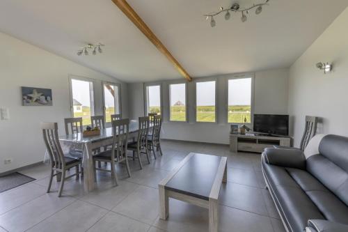 a living room with a table and a couch at Etoile des Grèves in Ardevon