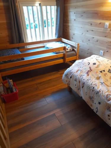 a bedroom with two beds in a log cabin at LA PLANTATION in Saint-André