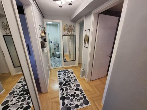 a hallway with a black and white rug on the floor at Luxury Apartment EMAS Old town Sarajevo dream view in Sarajevo