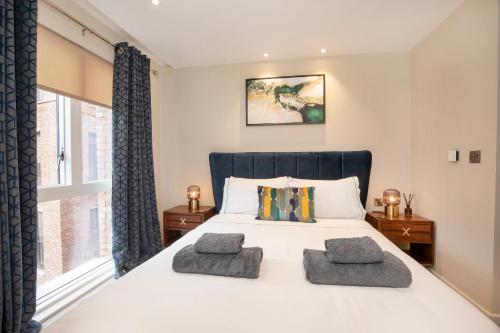 a bedroom with a large bed with two pillows on it at York Central No 1, within the city walls, free parking in York