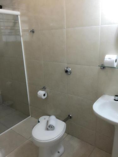 a bathroom with a toilet and a sink at Hotel Estação Express in Curitiba