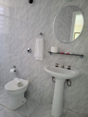 a bathroom with a sink and a toilet and a mirror at Hotel Estação Express in Curitiba