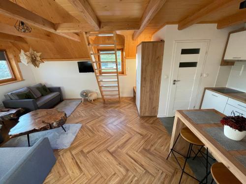 a living room with wooden ceilings and a wooden floor at Smrekowe Zacisze in Bańska Niżna