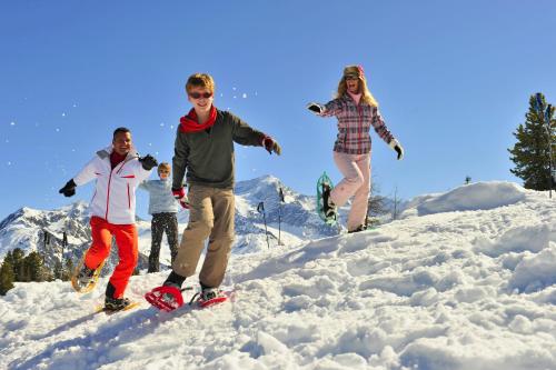 a group of people jumping in the snow at VVF La Plagne Montchavin Paradiski in Bellentre
