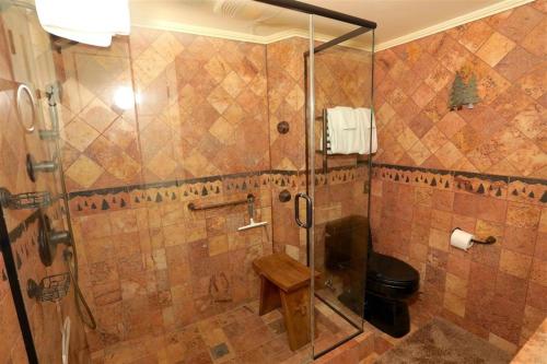 a bathroom with a shower with a glass door at Seven Springs 1 Bedroom Premium Condo, Ski In Ski Out condo in Champion